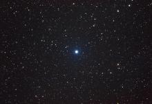 A blue white star on a dark background.